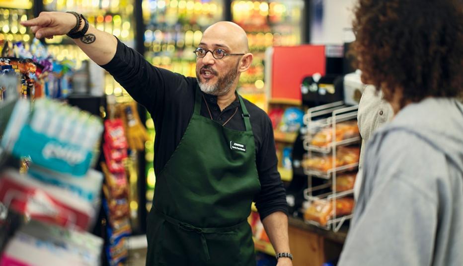 Payroll Deduction Retirement Programs Build Economic Security A small business owner at work in his small convenience store.