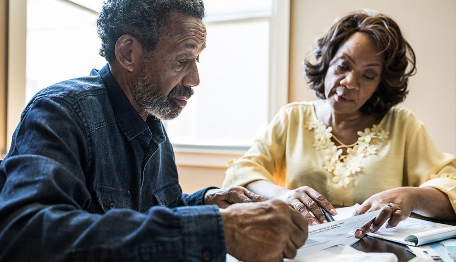 Senior couple paying bills at home