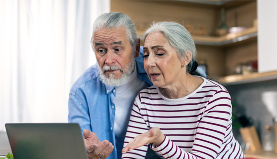 Senior Couple Reviewing Finances, Shocked by Fraud Senior Couple Reviewing Finances, Shocked by Fraud