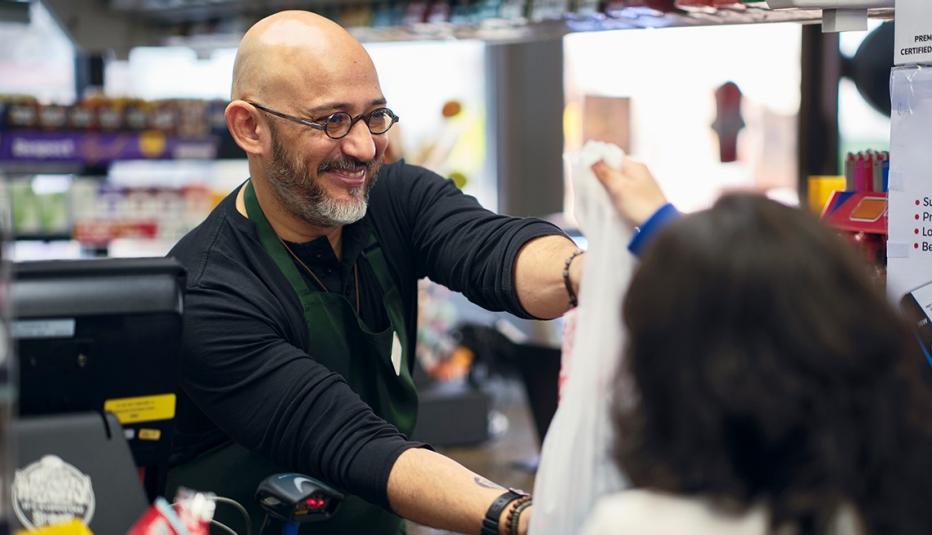 Someone buying groceries at a convenience store