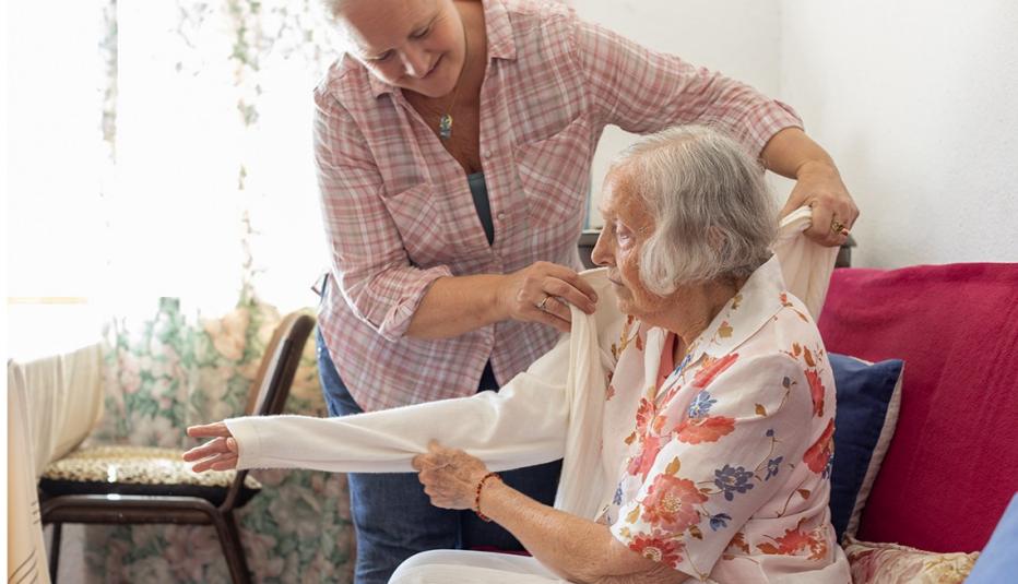 Woman providing caregiving to an older woman