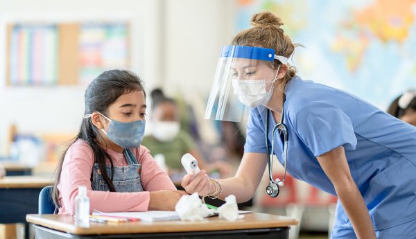 nurse with thermometer and child