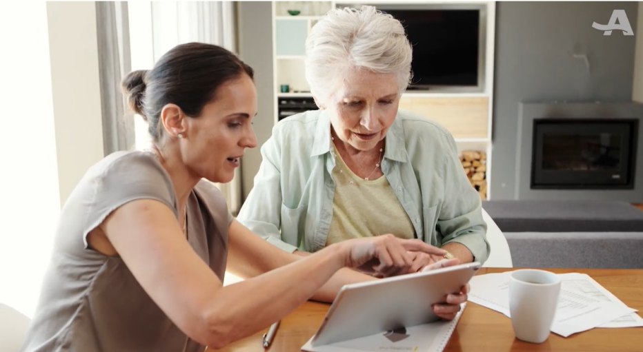 Valuing the Invisible Labor of Family Caregivers older mother being helped by daughter using an iPad