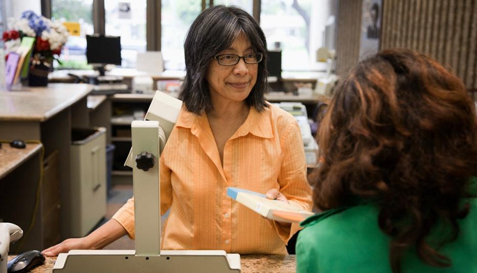 librarian handing a patron her book