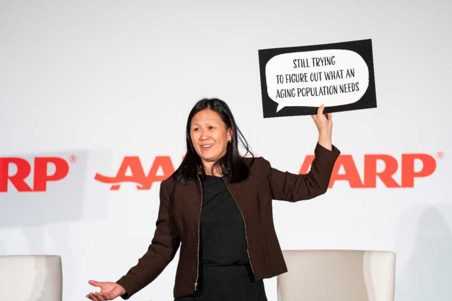 presenter holding up sign that says "still trying to figure out what an aging population needs"