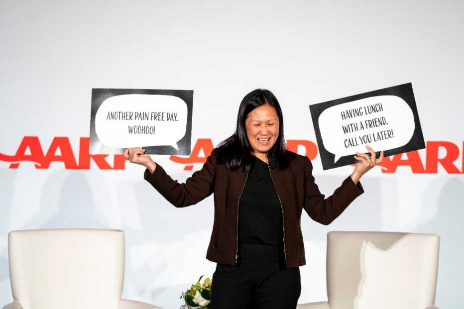 presenter holding up 2 signs that say "another pain free day. woohoo!" and "having lunch with a friend. Call you later."