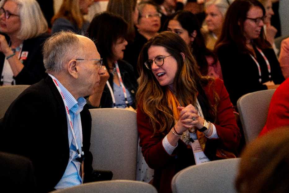 two audience members talking 
