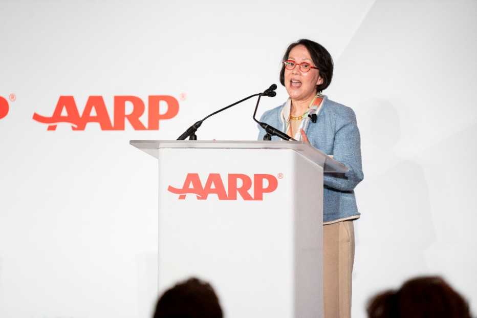 presenter at lectern in front of conference audience