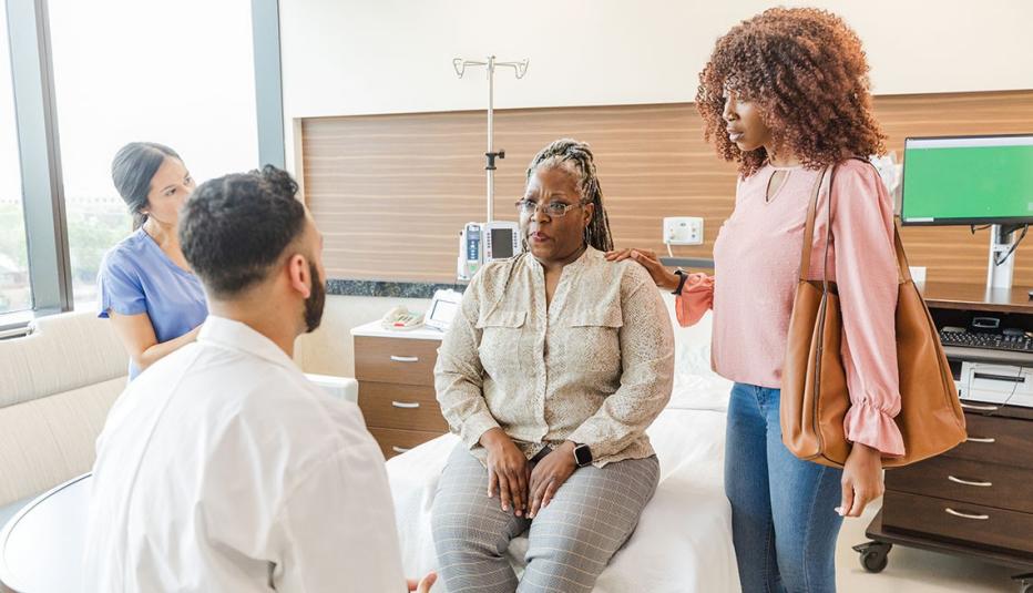 Adult daughter supports her mother when she gets bad news from emergency room personnel.