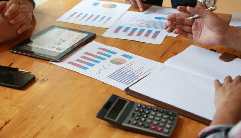 table of documents being examined by people