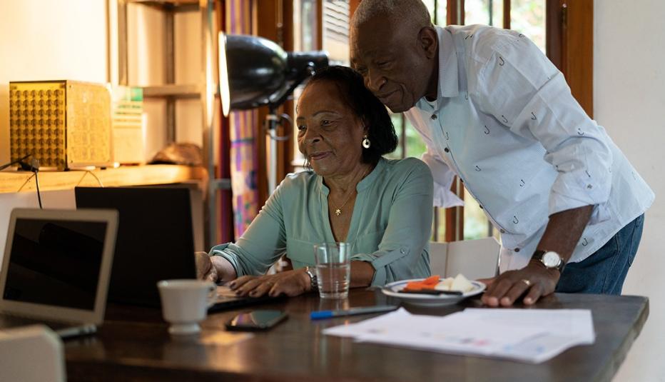 older couple reading the computer older couple reading the computer