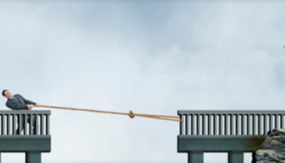 person pulling rope to other side of a bridge