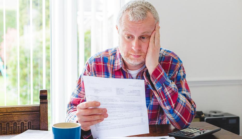 worried man checking bills