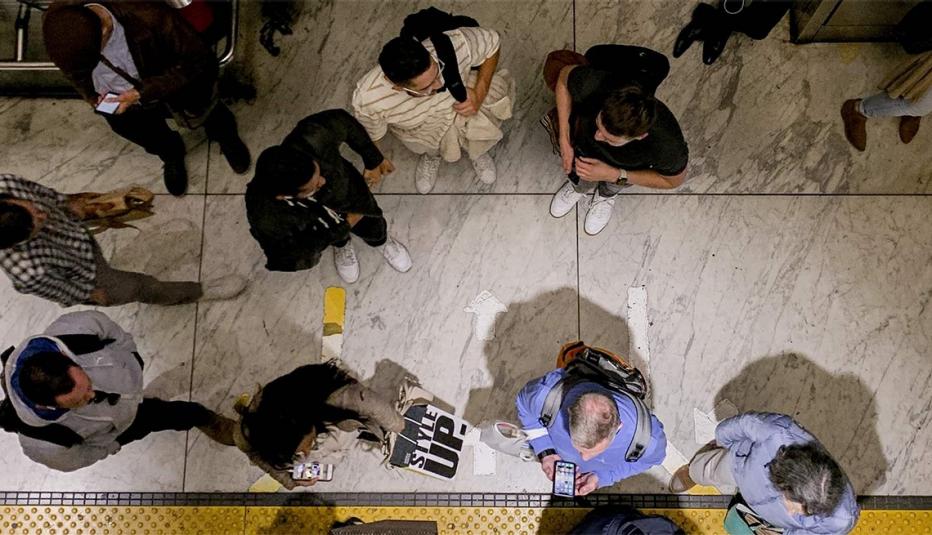 Pew image image from above of people moving about a room