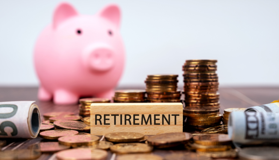 pink piggy bank in back of coins, cash & "retirement" text on wood block