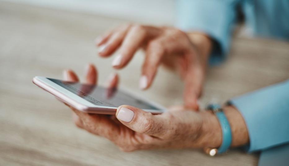Shot of a businesswoman's hands using a smartphone in an office
