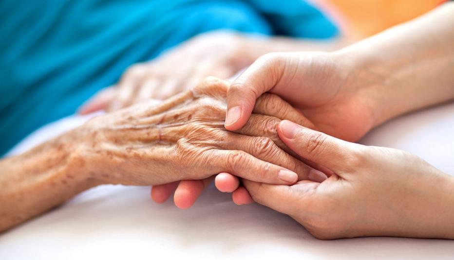 Woman holding senior woman&rsquo;s hand