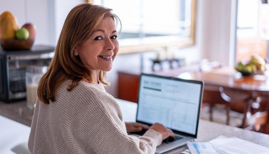 Older woman paying bills on her laptop