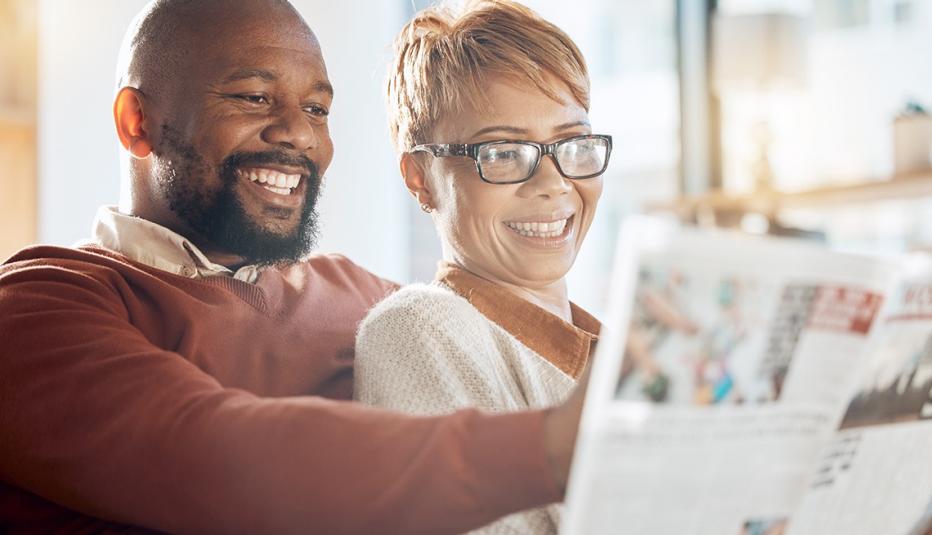 Older Couple Reading a Magazine An older couple sits close together sharing a magazine.