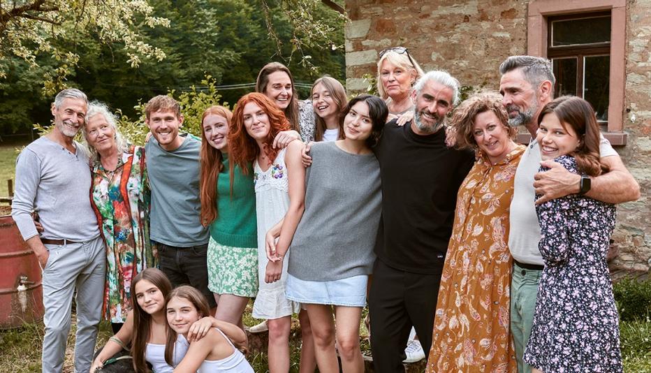 extended family posing outside extended, multi-generational family posing for a photo outside