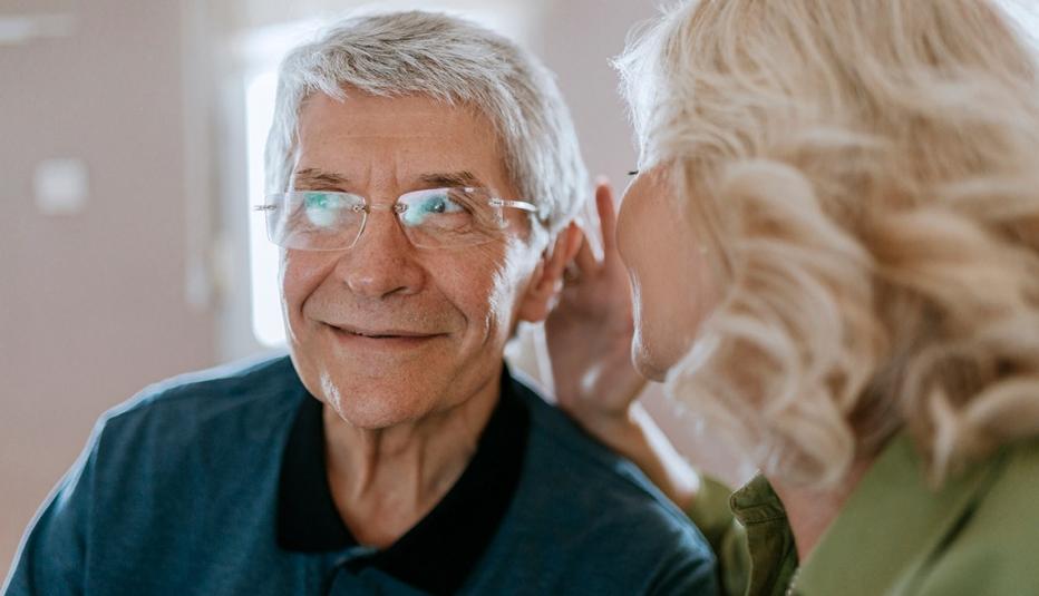 Woman whispering in man's ear