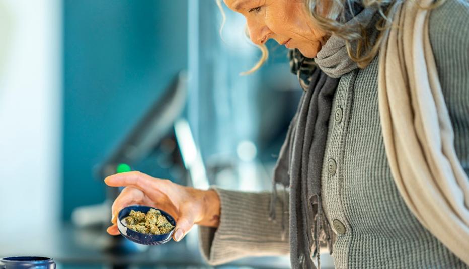 Older Woman Examining Marijuana Buds Older Woman Examining Marijuana Buds