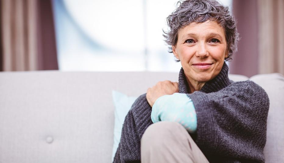 Portrait of smiling woman sitting on sofa