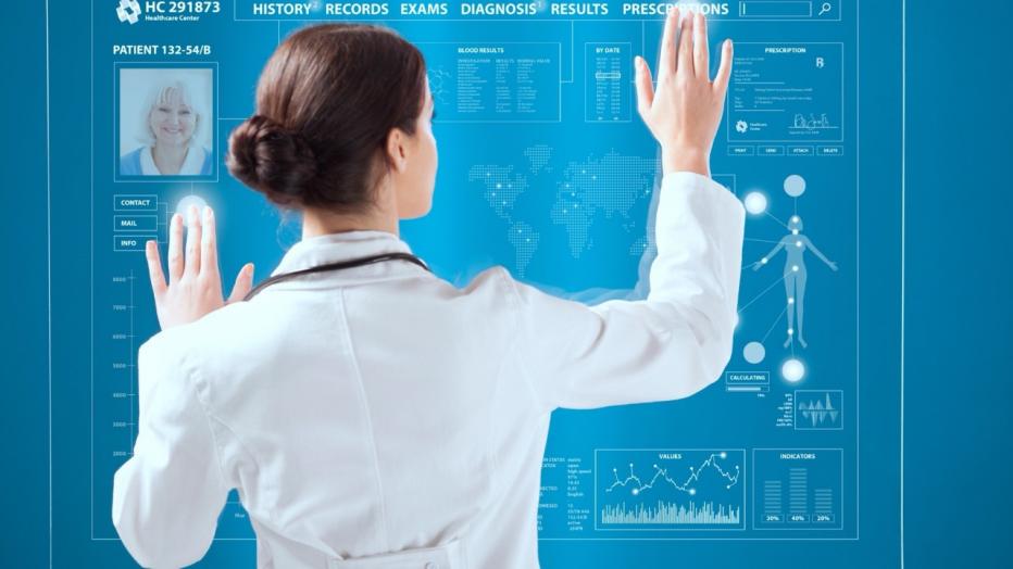 Doctor looking at a patient&rsquo;s record on a touchscreen