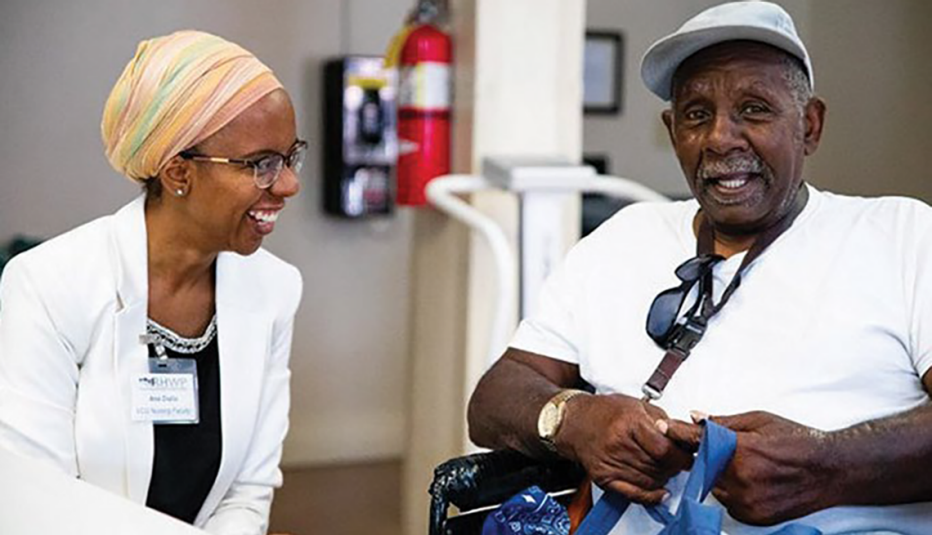 laughing woman sitting next to smiling man