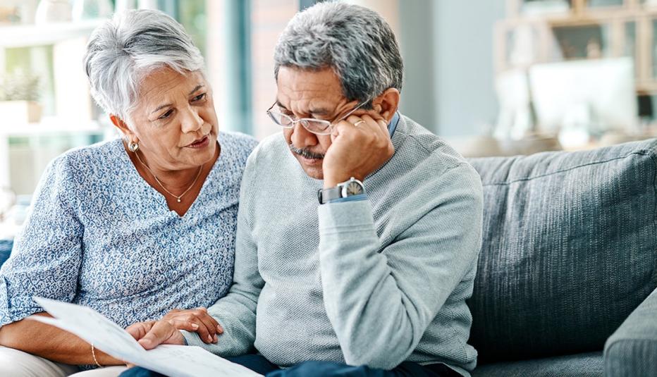 Shot of a mature couple looking worried while going through paperwork together at home