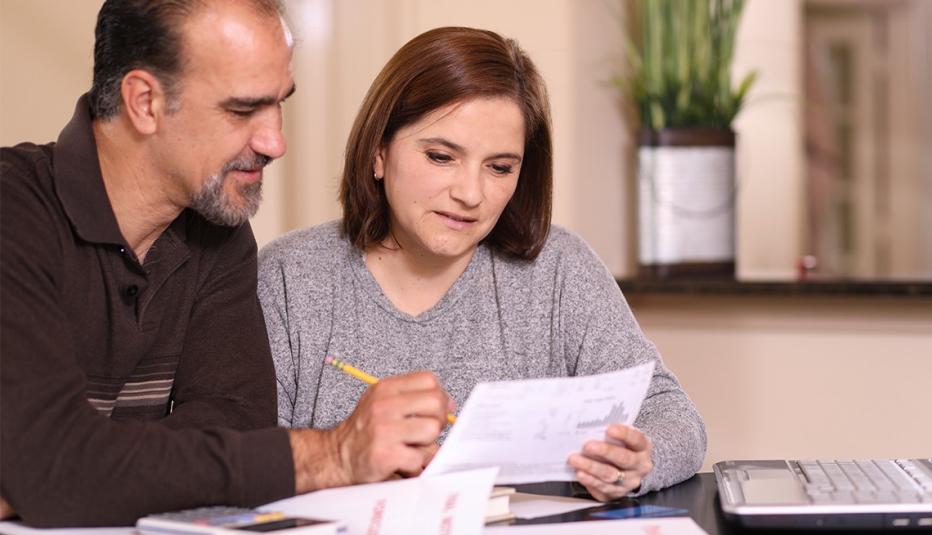 Policy Options to Improve Older Adults’ Health Insurance Affordability: A Series Overview Mature couple working on family finances at home together. They pay bills, complete income taxes, apply for home loan, investing, or pay off a credit card.