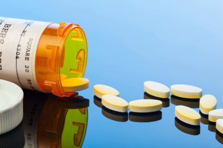 Prescription Drug Capsules Spilled on Reflective Surface