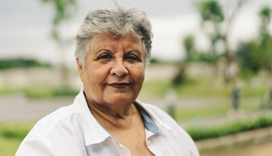 Positive Emotion portrait of an Asian woman senior with green background