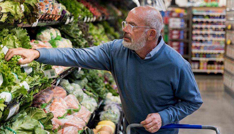 The Supplemental Nutrition Assistance Program (SNAP) and Its Role in the Lives of Older Adults Older man reaching for vegetables in the grocery store.