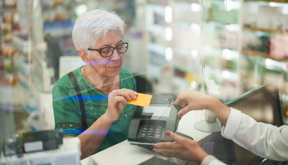 A New Era for State Pharmaceutical
Assistance Programs That Serve Older
Adults Senior woman paying for medicines at pharmacy checkout