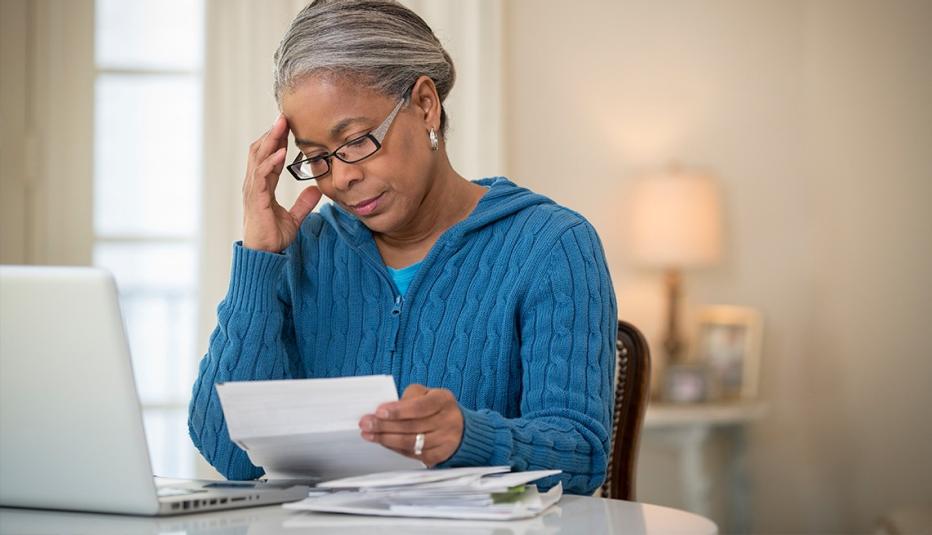 Senior African American woman paying bills