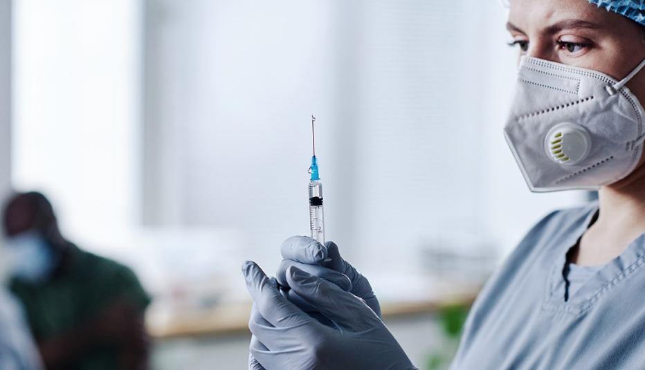 Nurse Preparing a Syringe for a Shot