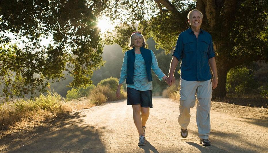 mature couple walking togther at a park mature couple walking togther at a park