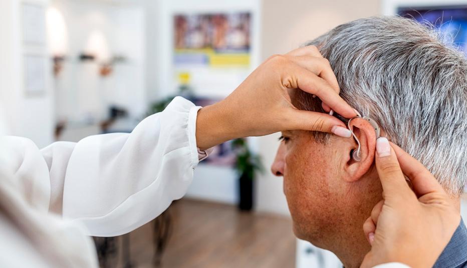 Older White Man Being Fitted for Hearing Aid