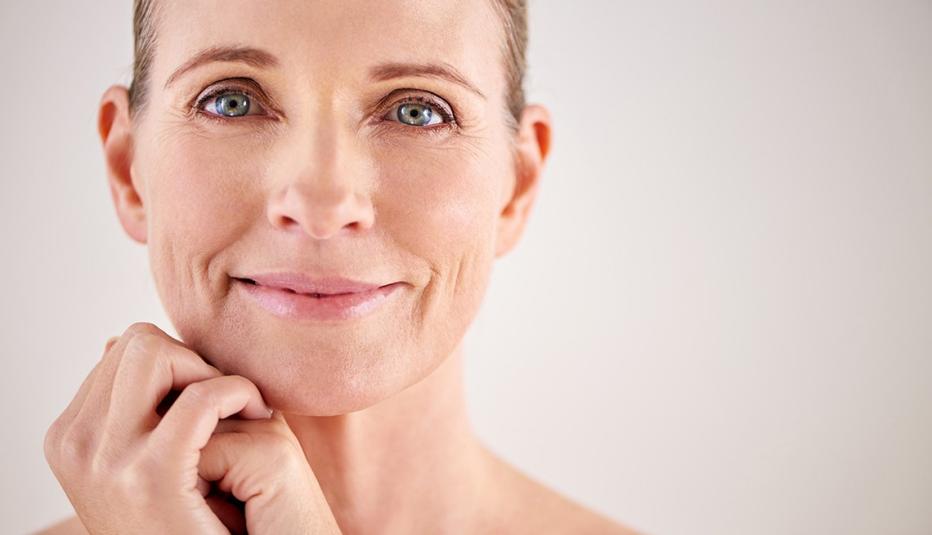 Cropped studio portrait of an attractive mature woman showing the healthy skin on her face and hands.