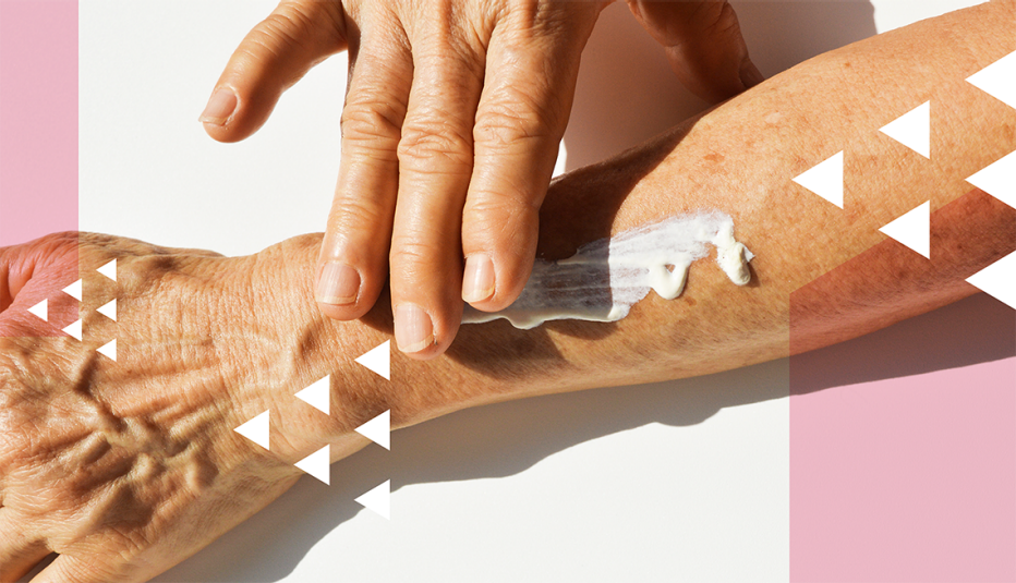 close shot of a womans arm while she rubs in a blob of lotion with her other hand