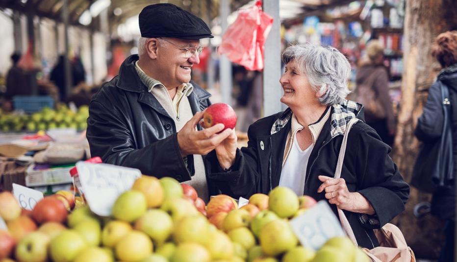 Livability Index Fact Sheets Smiling senior couple buying fruit together at farmer's market.