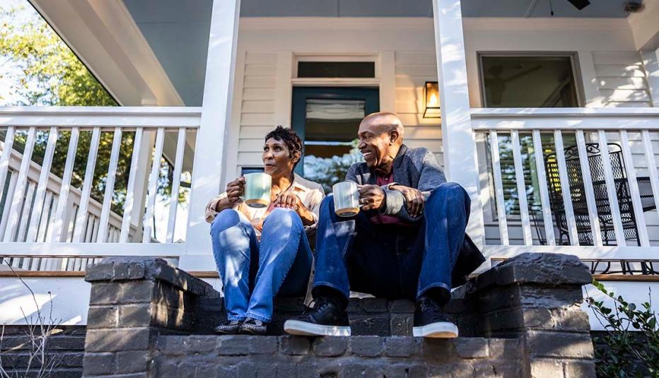 Older couple having coffee on front porch of their house Older couple having coffee on front porch of their house