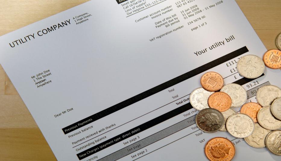 utility bill with coins
