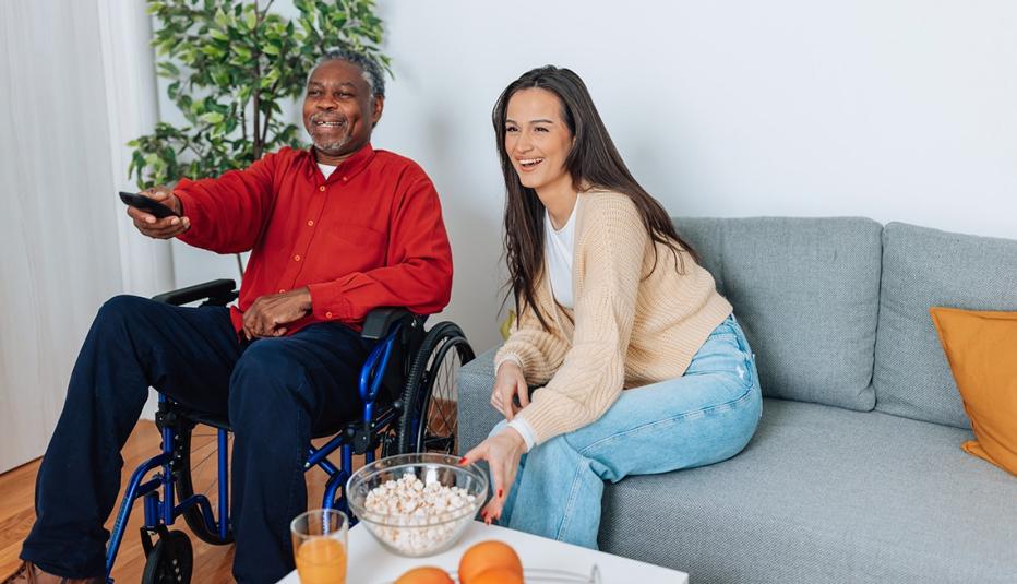 Caregiver and care receiver watching TV together Caregiver and care receiver watching TV together