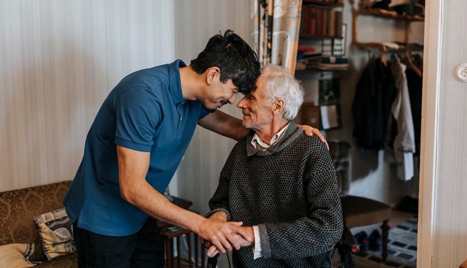 Son providing caregiving for an aging father Son providing caregiving for an aging father