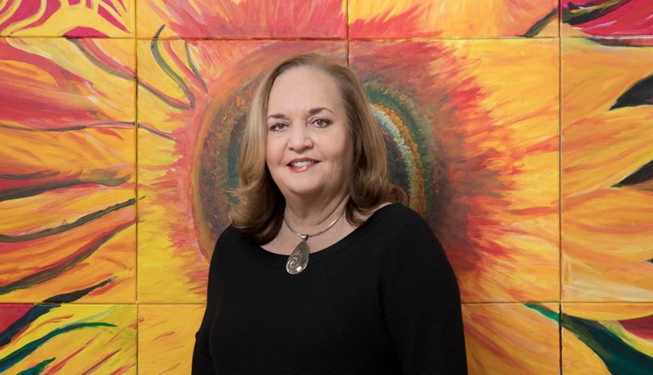 Kellen Kee McIntire in front of painting with flowers