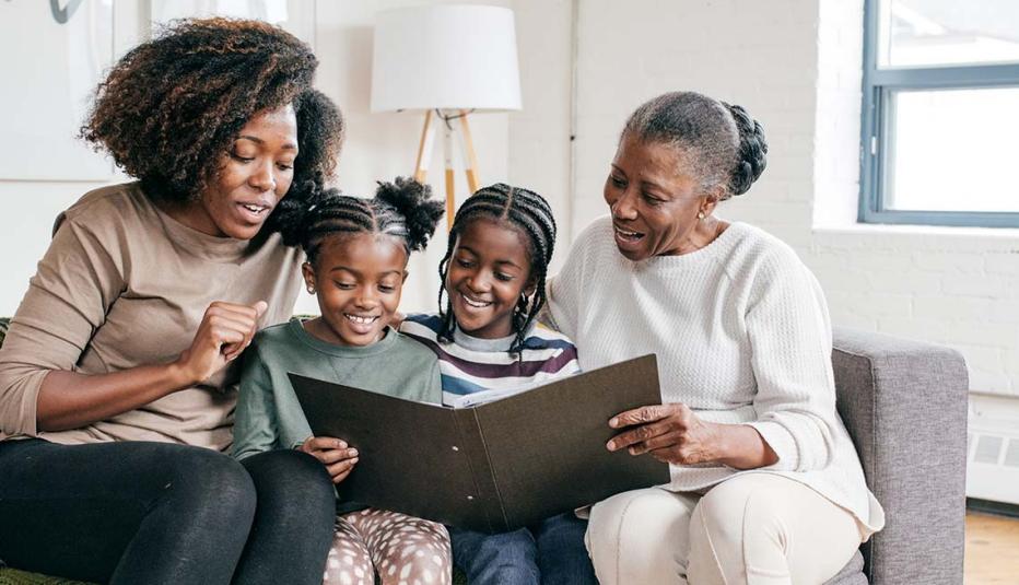 Three generations looking at a photo album