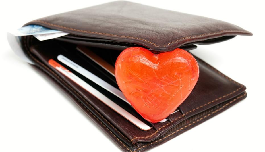 A wallet opened up with a heart shape inside A wallet opened up with a heart shape inside