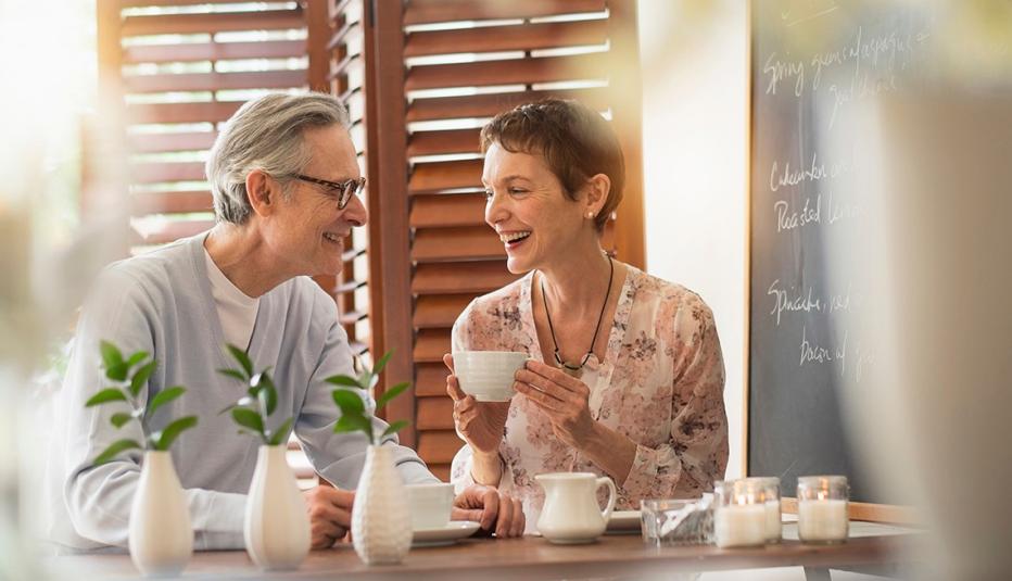 An older man and woman talking while drinking coffee An older man and woman talking while drinking coffee